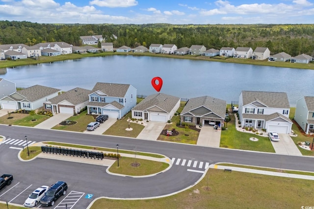 aerial view with a residential view, a water view, and a wooded view
