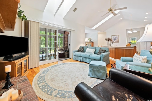 living room with recessed lighting, visible vents, ceiling fan, high vaulted ceiling, and light wood finished floors