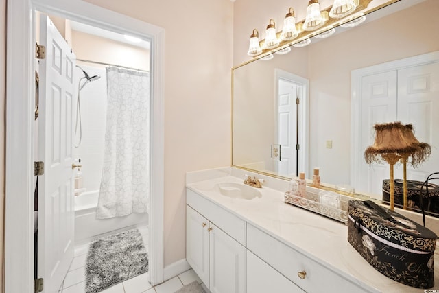 bathroom featuring tile patterned flooring, shower / bath combo with shower curtain, vanity, and baseboards