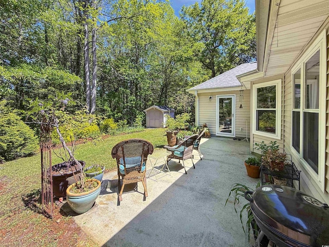 view of patio featuring an outbuilding, grilling area, and a shed