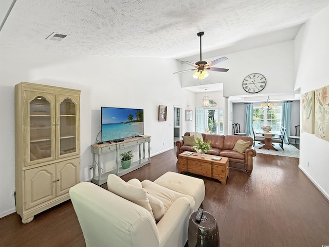 living room featuring visible vents, high vaulted ceiling, a ceiling fan, and a textured ceiling