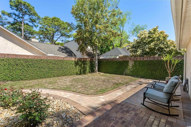 view of yard featuring a patio and a fenced backyard