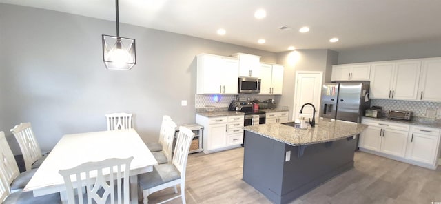 897 Wild Leaf Loop, Conway, SC 29526 - kitchen with stainless steel appliances, backsplash, white cabinetry, and recessed lighting