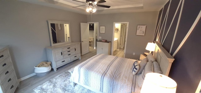 897 Wild Leaf Loop, Conway, SC 29526 - bedroom with light wood-style floors, a raised ceiling, and ensuite bath