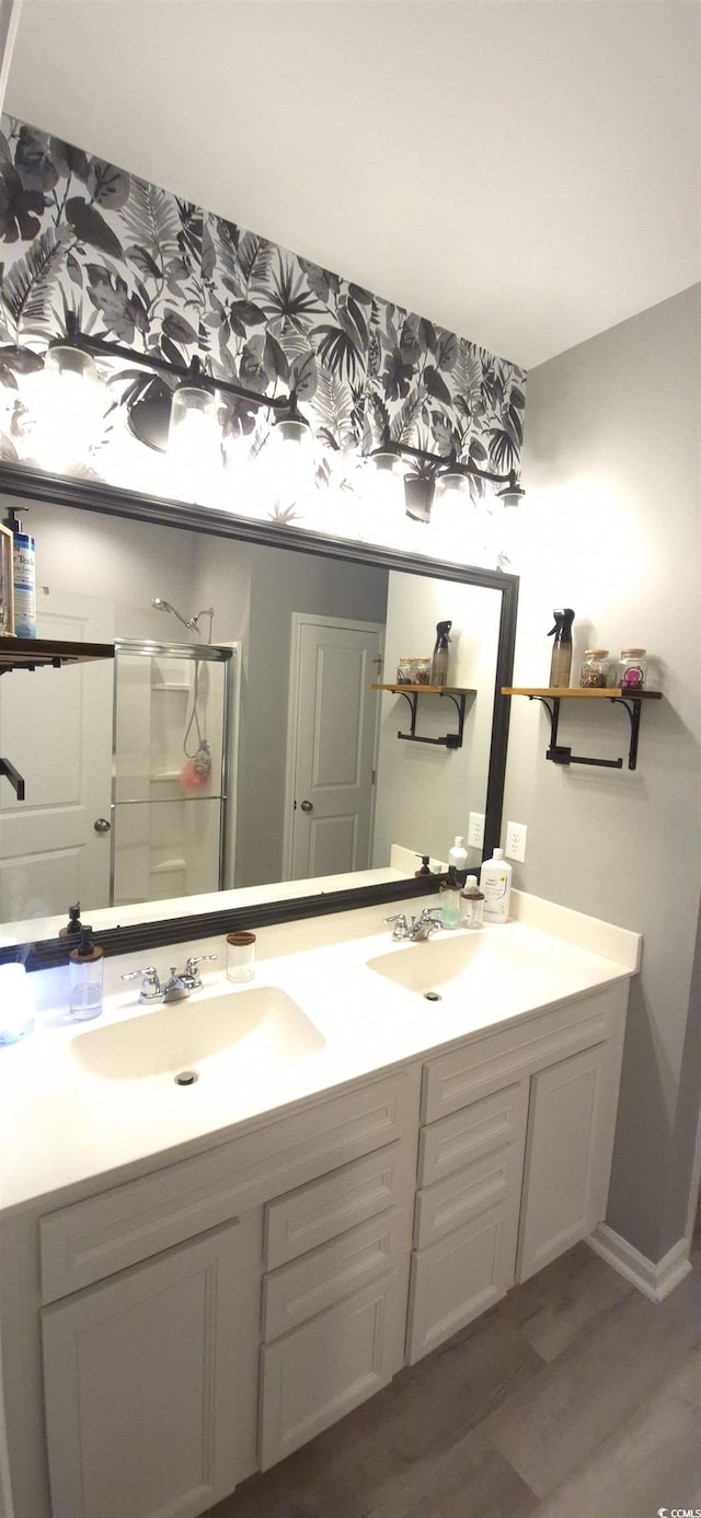 897 Wild Leaf Loop, Conway, SC 29526 - bathroom featuring double vanity, wood finished floors, and a shower with door