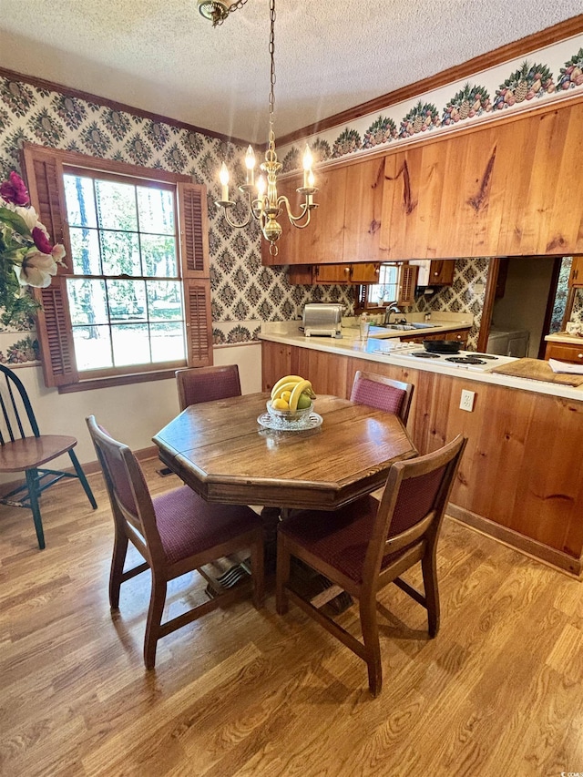 116 Green Lake Dr, Myrtle Beach, SC 29572 - dining room featuring wallpapered walls, a textured ceiling, ornamental molding, and an inviting chandelier