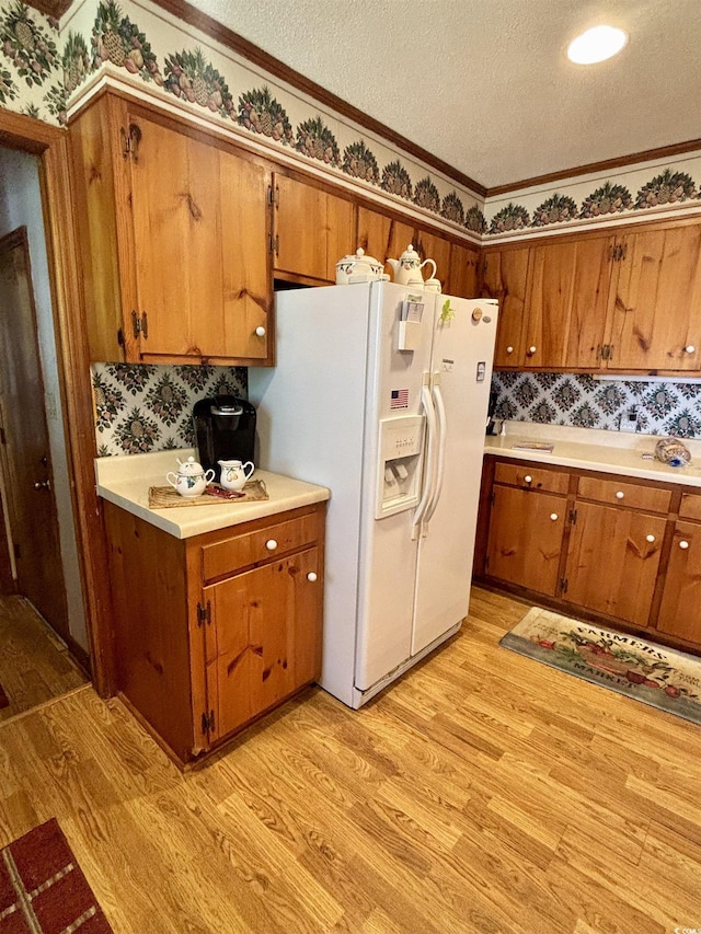 116 Green Lake Dr, Myrtle Beach, SC 29572 - kitchen with brown cabinetry, a textured ceiling, white refrigerator with ice dispenser, and light wood-style flooring