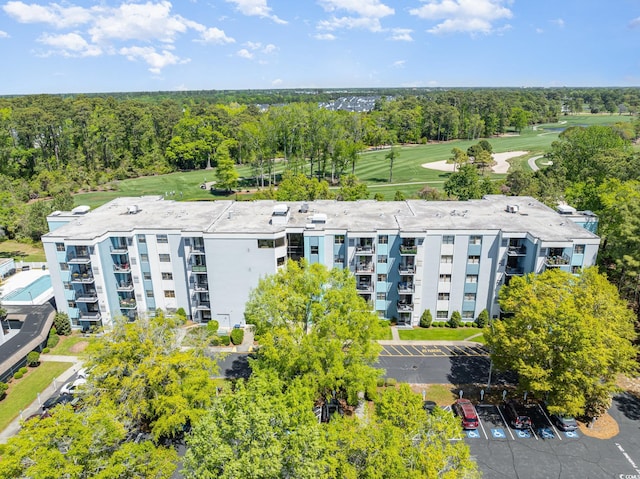 drone / aerial view of apartment complex / building and a golf club