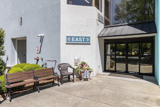 5001 Little River Rd Unit 501E, Myrtle Beach, SC 29577 - doorway to property featuring a standing seam roof, stucco siding, metal roof, and french doors