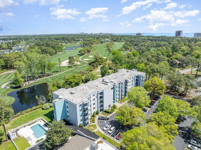 drone / aerial view of apartment complex, a large body of water, and a local golf course