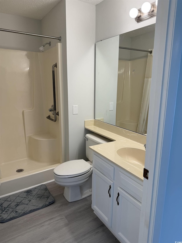 5001 Little River Rd Unit 501E, Myrtle Beach, SC 29577 - bathroom featuring wood finished floors, vanity, curtained shower, toilet, and a textured ceiling