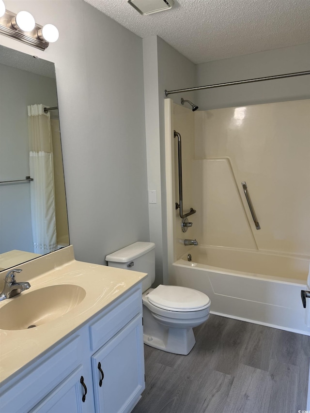 5001 Little River Rd Unit 501E, Myrtle Beach, SC 29577 - bathroom featuring wood finished floors, toilet, vanity, shower / bath combo with shower curtain, and a textured ceiling