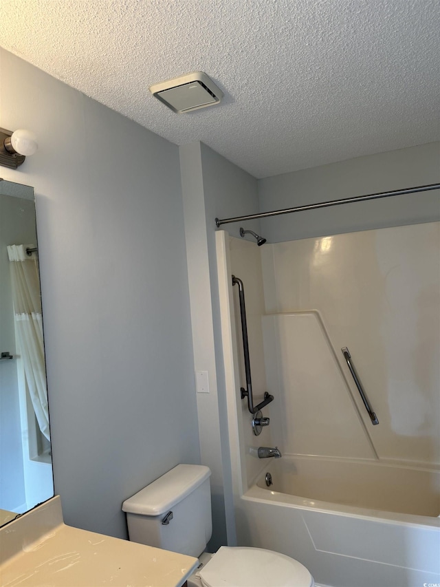 bathroom featuring toilet, a textured ceiling, shower / tub combination, and vanity
