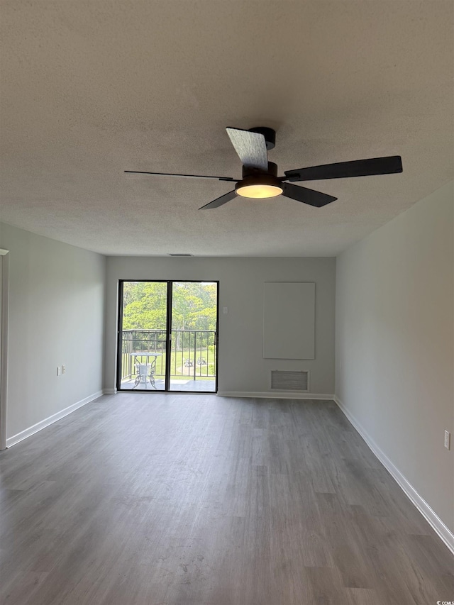 5001 Little River Rd Unit 501E, Myrtle Beach, SC 29577 - unfurnished living room featuring wood finished floors, ceiling fan, baseboards, and a textured ceiling
