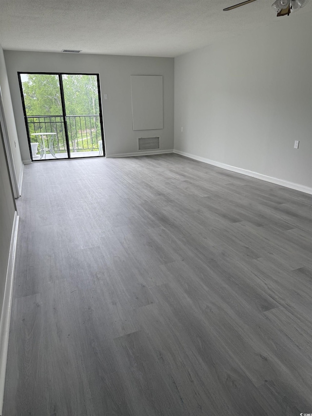 unfurnished living room featuring dark wood-style floors and baseboards