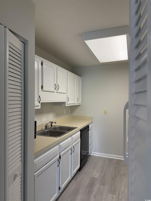 5001 Little River Rd Unit 501E, Myrtle Beach, SC 29577 - kitchen featuring dishwasher, a sink, light wood-type flooring, white cabinetry, and light countertops