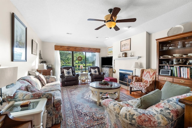 111 Cedar Ridge Ln, Conway, SC 29526 - living room with ceiling fan, a glass covered fireplace, wood finished floors, and a textured ceiling