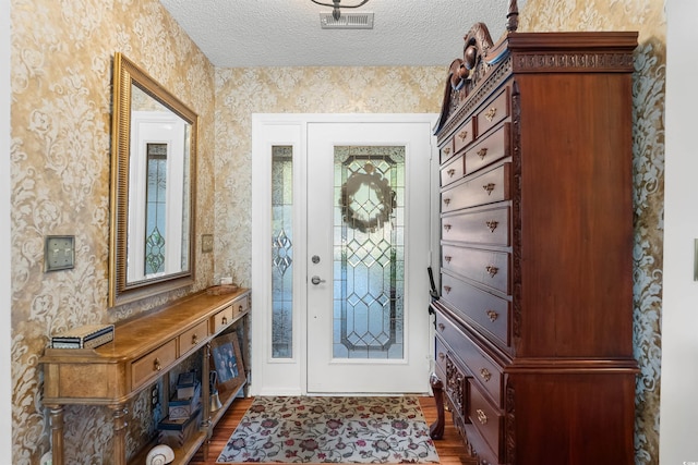 111 Cedar Ridge Ln, Conway, SC 29526 - foyer entrance featuring wallpapered walls, dark wood-style floors, and a textured ceiling