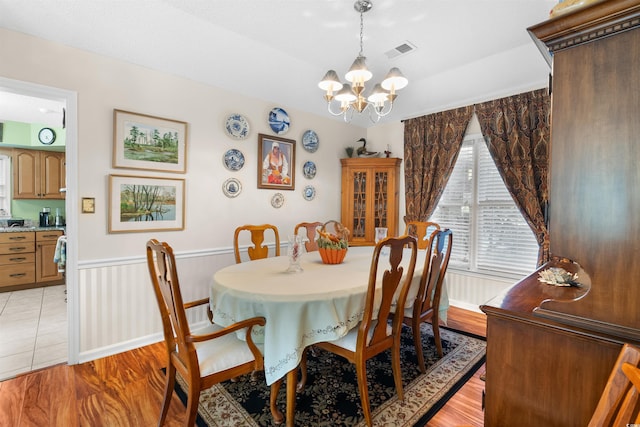 111 Cedar Ridge Ln, Conway, SC 29526 - dining room featuring a chandelier, a wainscoted wall, and light wood-style flooring