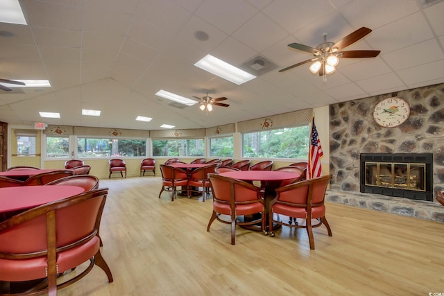 111 Cedar Ridge Ln, Conway, SC 29526 - dining area featuring wood finished floors, a ceiling fan, a stone fireplace, healthy amount of natural light, and vaulted ceiling