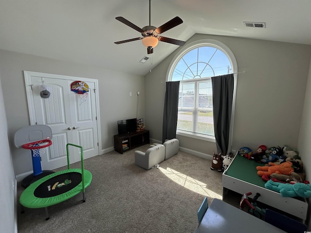 rec room with a ceiling fan, vaulted ceiling, carpet, and baseboards