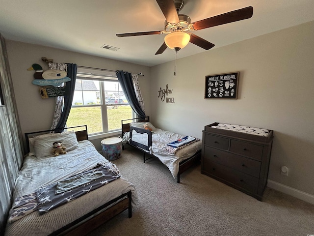 carpeted bedroom featuring a ceiling fan and baseboards