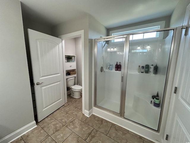 full bath featuring a stall shower, toilet, baseboards, and tile patterned flooring