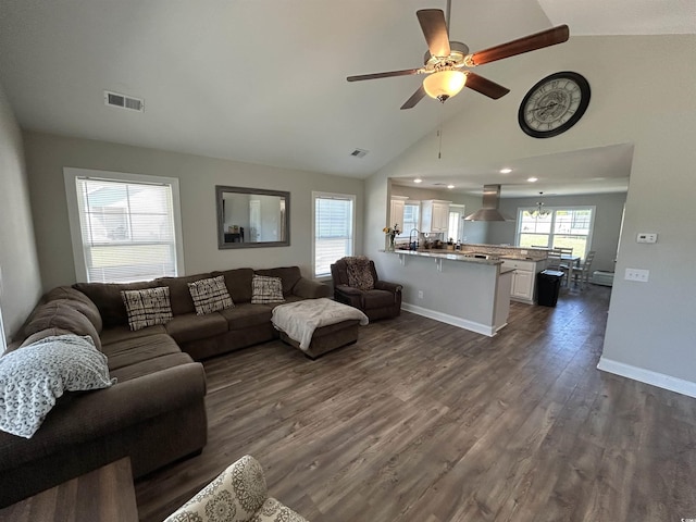 living area with vaulted ceiling, dark wood-type flooring, ceiling fan, baseboards, and recessed lighting