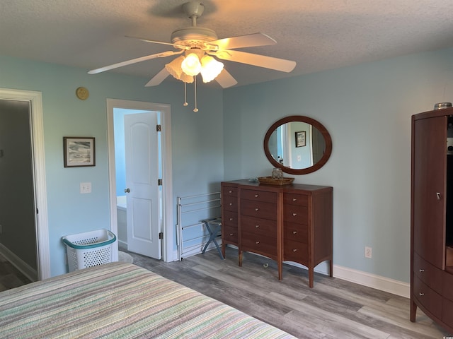 1516 Edge Dr Unit 101, North Myrtle Beach, SC 29582 - bedroom with a textured ceiling, baseboards, a ceiling fan, and wood finished floors