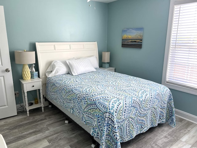 1516 Edge Dr Unit 101, North Myrtle Beach, SC 29582 - bedroom with baseboards, multiple windows, and wood finished floors