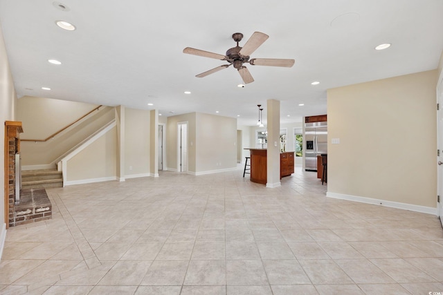 unfurnished living room featuring light tile patterned floors, recessed lighting, a ceiling fan, stairway, and baseboards