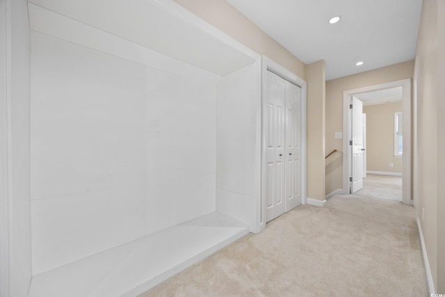hallway featuring recessed lighting, light colored carpet, baseboards, and an upstairs landing