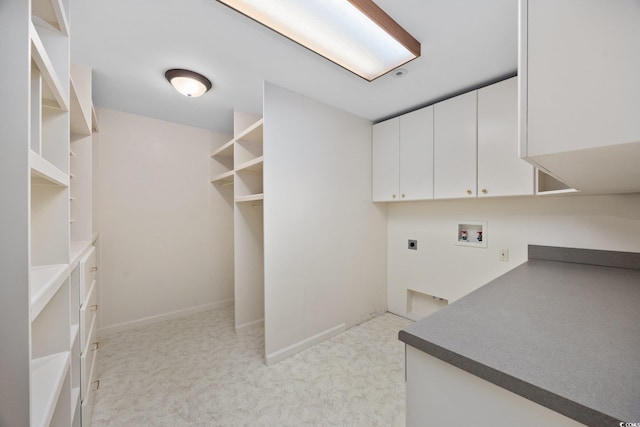 laundry area with hookup for an electric dryer, washer hookup, cabinet space, and light carpet