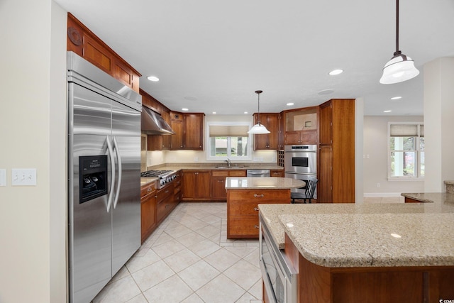 kitchen featuring appliances with stainless steel finishes, light tile patterned floors, a sink, ventilation hood, and plenty of natural light