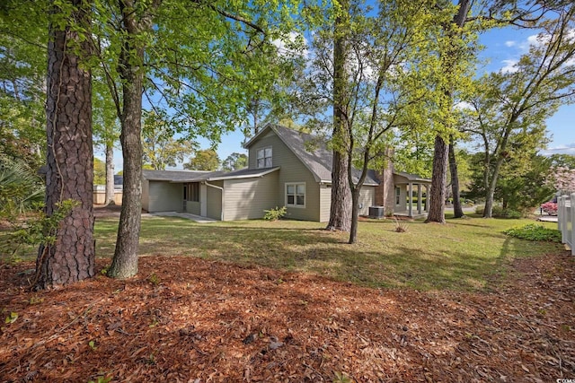 view of home's exterior with a lawn and central air condition unit