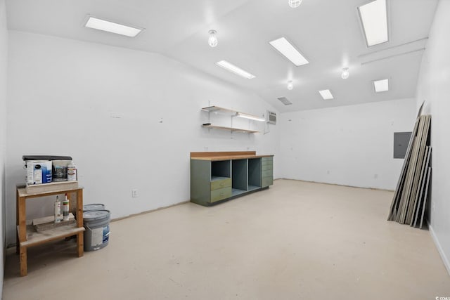 misc room featuring lofted ceiling and concrete floors