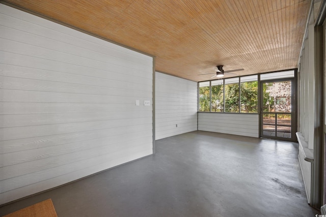 unfurnished sunroom with ceiling fan