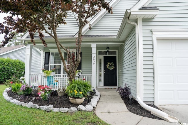property entrance featuring covered porch and an attached garage