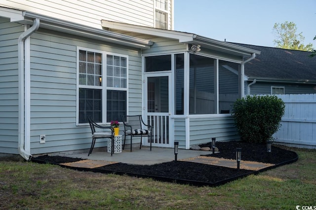 back of house with a sunroom and fence