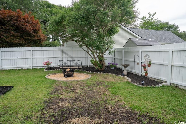 view of yard with a fire pit