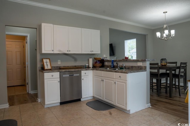 kitchen featuring stainless steel dishwasher, a peninsula, a sink, ornamental molding, and white cabinetry