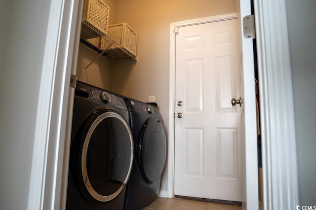 washroom with washing machine and clothes dryer and light tile patterned floors