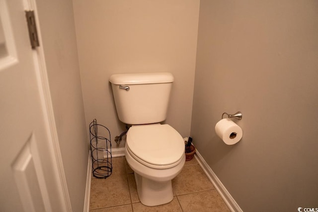 bathroom with toilet, tile patterned floors, and baseboards