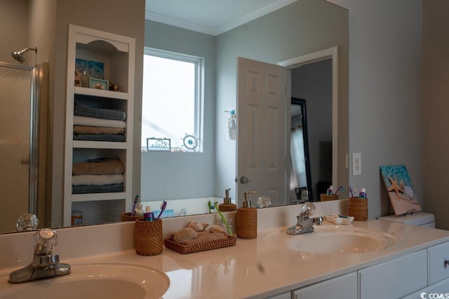 bathroom featuring double vanity, a shower with shower door, and ornamental molding