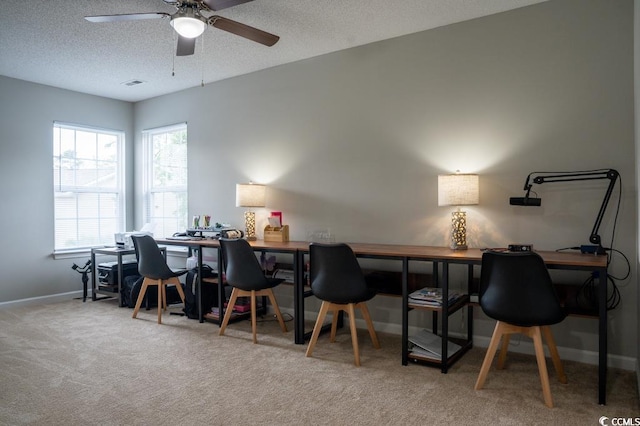 office area featuring baseboards, carpet floors, a ceiling fan, and a textured ceiling