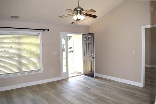 foyer featuring visible vents, wood finished floors, a ceiling fan, and vaulted ceiling
