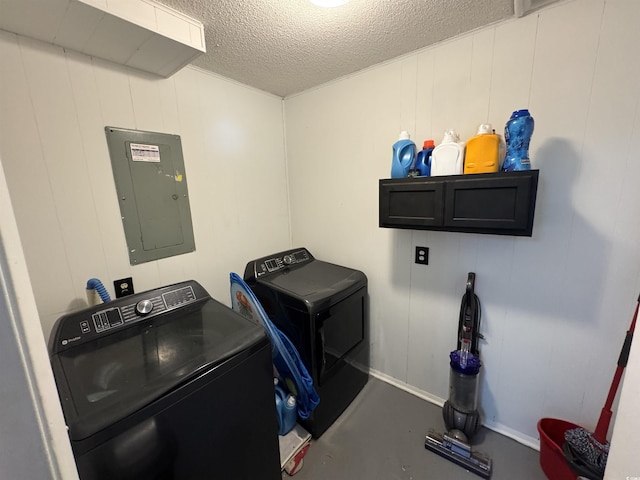 laundry area featuring laundry area, independent washer and dryer, electric panel, a decorative wall, and a textured ceiling