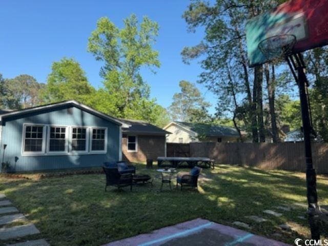 back of house with a yard and fence