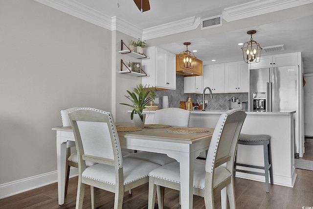 dining room with visible vents, crown molding, baseboards, recessed lighting, and dark wood finished floors