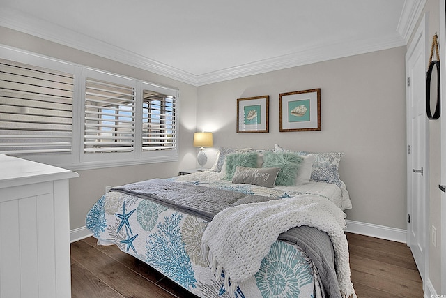 bedroom featuring baseboards, crown molding, and wood finished floors